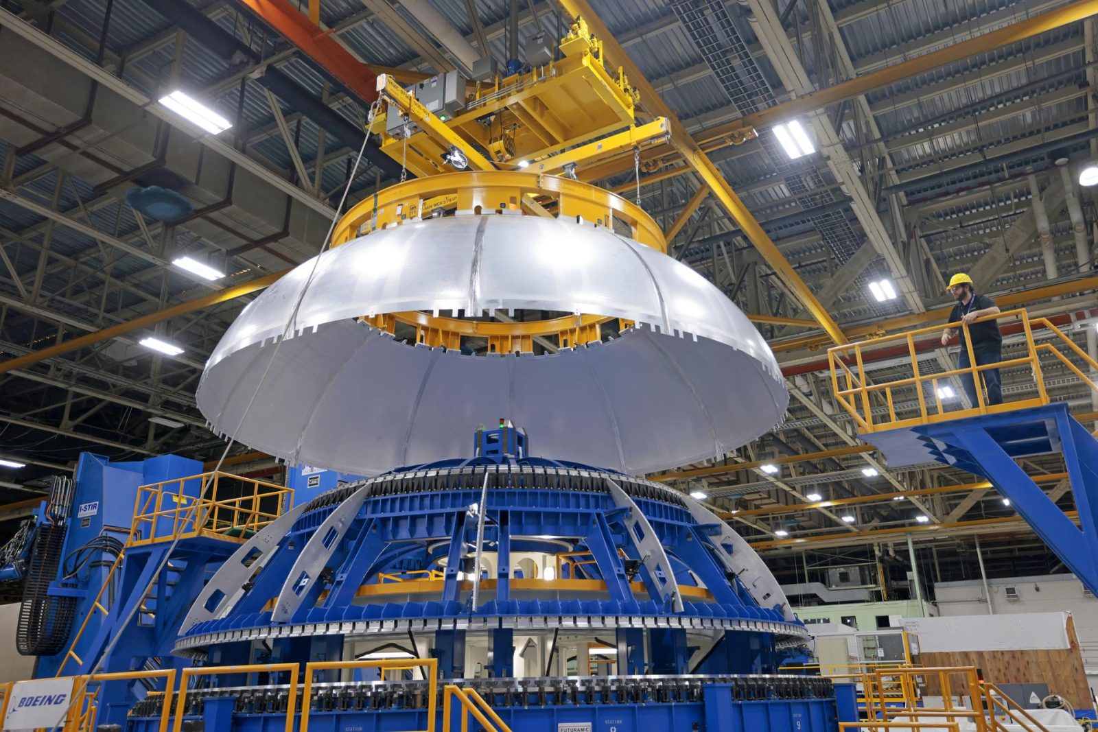 This image shows teams at NASA’s Michoud Assembly Facility lifting a completed dome off of a robotic weld tool on Nov. 21.