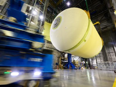 Teams at NASA’s Michoud Assembly Facility in New Orleans lift a liquid oxygen tank from a horizontal to a vertical position and place it into a production cell on July 12.