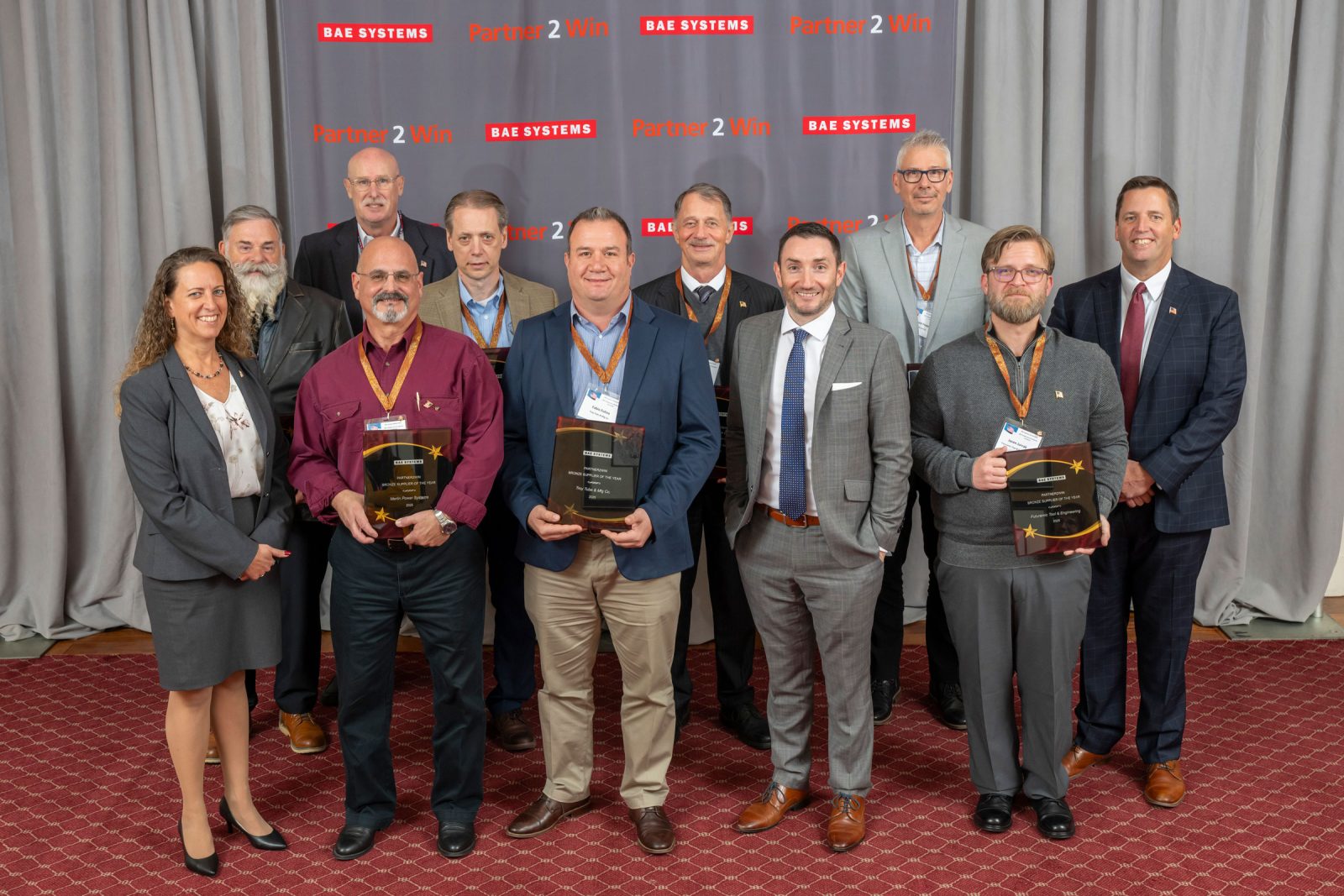 BAE Systems’ Combat Mission Systems Bronze Medallion Award presentation group photo at the seventh annual ‘Partner2Win’ supplier symposium.
